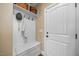 Mudroom featuring built-in bench and coat hooks, shelving and white door at 4229 Cats Paw Ct, Wake Forest, NC 27587
