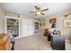 A bright office features built-in bookshelves, neutral walls, and a ceiling fan at 4229 Cats Paw Ct, Wake Forest, NC 27587