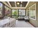 Cozy screened porch featuring comfortable seating and ambient string lights for evening relaxation at 4229 Cats Paw Ct, Wake Forest, NC 27587