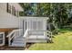 View of porch attached to home with decorative white lattice and steps down to yard at 4404 Susan Dr, Raleigh, NC 27603
