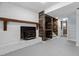 Finished basement showcasing a white brick fireplace with a wood mantel and a stairwell feature at 4404 Susan Dr, Raleigh, NC 27603