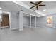 Open basement with painted floor, large ceiling fan and glass doors at 4404 Susan Dr, Raleigh, NC 27603