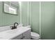 Bathroom featuring beadboard paneling, vanity sink, and toilet at 4404 Susan Dr, Raleigh, NC 27603