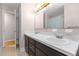 Bathroom featuring double sinks, a vanity with dark wood cabinets, and neutral-toned walls at 4404 Susan Dr, Raleigh, NC 27603