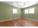 Bedroom with hardwood floors, ceiling fan and large windows at 4404 Susan Dr, Raleigh, NC 27603