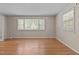 Bedroom featuring hardwood floors and large windows, providing ample natural light and a comfortable atmosphere at 4404 Susan Dr, Raleigh, NC 27603