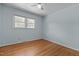 Comfortable bedroom with hardwood floors and a ceiling fan, offering a bright and airy ambiance at 4404 Susan Dr, Raleigh, NC 27603