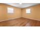 Bedroom with hardwood floors, natural light from two windows, and neutral paint at 4404 Susan Dr, Raleigh, NC 27603