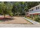 Open driveway with stone pavers and adjacent grass and rock landscaping leads to a cozy home at 4404 Susan Dr, Raleigh, NC 27603