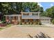 Charming two-story house with a gravel driveway, a garage, and well-maintained landscaping at 4404 Susan Dr, Raleigh, NC 27603