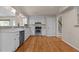 Bright kitchen with stainless steel oven and stove, tiled backsplash, and access to the staircase at 4404 Susan Dr, Raleigh, NC 27603