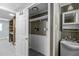 Functional laundry area with convenient shelving, white cabinetry, and sink at 4404 Susan Dr, Raleigh, NC 27603