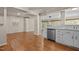 Open-concept living space featuring hardwood floors and seamlessly connecting the living room and kitchen at 4404 Susan Dr, Raleigh, NC 27603