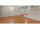 Open concept living room featuring hardwood floors, neutral paint, and large windows at 4404 Susan Dr, Raleigh, NC 27603