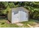 A white storage shed in the backyard, offers practical storage space and convenience at 4404 Susan Dr, Raleigh, NC 27603