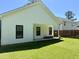 View of backyard with well-maintained lawn and covered patio area at 451 N Lincoln St, Benson, NC 27504