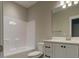 Clean bathroom featuring a bathtub, toilet, vanity and modern sink at 451 N Lincoln St, Benson, NC 27504