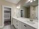 Elegant bathroom with double sinks, quartz countertop, modern fixtures, and access to a walk-in closet at 451 N Lincoln St, Benson, NC 27504