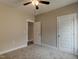 Carpeted bedroom with ceiling fan and two doors in view at 451 N Lincoln St, Benson, NC 27504