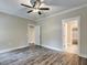 Spacious bedroom features neutral walls, a ceiling fan, modern flooring, and closet access at 451 N Lincoln St, Benson, NC 27504