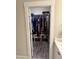 View into a fully stocked walk-in closet with shelves and hanging clothes at 451 N Lincoln St, Benson, NC 27504