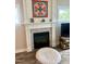 Living room fireplace with grey tile surround, white mantel, and natural light from nearby windows at 451 N Lincoln St, Benson, NC 27504