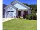 Charming white home with a well-manicured lawn and an attached two-car garage at 451 N Lincoln St, Benson, NC 27504
