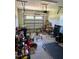A residential garage with a variety of items, including bikes, a treadmill and lawncare equipment at 451 N Lincoln St, Benson, NC 27504