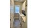 Well-lit laundry room features modern washer and dryer, stylish cabinets, and sleek herringbone tile flooring at 451 N Lincoln St, Benson, NC 27504