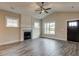 Spacious living room with a fireplace, large windows, modern flooring, and a ceiling fan at 451 N Lincoln St, Benson, NC 27504