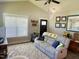 Cozy living room features neutral tones, large window, stylish decor, and vaulted ceiling with ceiling fan at 451 N Lincoln St, Benson, NC 27504