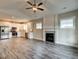 Open floor plan with a kitchen, living room fireplace, and stylish, durable floors at 451 N Lincoln St, Benson, NC 27504