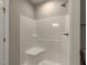 Modern shower features white tile surround, built-in bench, and sleek hardware at 451 N Lincoln St, Benson, NC 27504