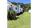 Spacious, well-maintained lawn showcases the side of the home and a wooden fence at 451 N Lincoln St, Benson, NC 27504