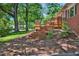 Inviting backyard deck and lush landscaping create a serene outdoor space with easy access to the house at 503 Tarleton Ave, Burlington, NC 27215