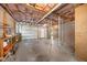 Unfinished basement area with exposed ceiling, cement floors, and a garage door at 503 Tarleton Ave, Burlington, NC 27215