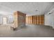 Unfinished basement featuring a partially bricked-in fireplace and access to stairs at 503 Tarleton Ave, Burlington, NC 27215