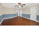 Large bedroom features hardwood floors, two-tone walls, a ceiling fan and three door ways at 503 Tarleton Ave, Burlington, NC 27215
