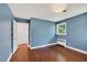 This bedroom has hardwood floors, two large windows that look out onto the green trees, and is painted light blue at 503 Tarleton Ave, Burlington, NC 27215