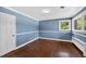 Serene blue bedroom with hardwood floors and natural lighting at 503 Tarleton Ave, Burlington, NC 27215