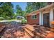 Spacious wooden deck featuring built-in seating, ideal for outdoor relaxation and entertaining, with a view of the neighborhood at 503 Tarleton Ave, Burlington, NC 27215