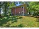 Back exterior view of brick home showing backyard landscaping and details of the house at 503 Tarleton Ave, Burlington, NC 27215