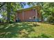 Back exterior view of brick home showing backyard landscaping and details of the house at 503 Tarleton Ave, Burlington, NC 27215