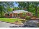 Charming brick home featuring a well-manicured lawn and mature trees, providing a peaceful and inviting curb appeal at 503 Tarleton Ave, Burlington, NC 27215