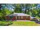 Charming brick home featuring a well-maintained lawn and inviting front entrance, and mature trees at 503 Tarleton Ave, Burlington, NC 27215