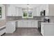 Charming kitchen with white cabinets, subway tile backsplash and stainless steel appliances at 503 Tarleton Ave, Burlington, NC 27215