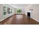 Bright living room with large windows, hardwood floors, and a fireplace, offering a cozy and elegant space at 503 Tarleton Ave, Burlington, NC 27215
