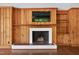 Inviting living room with wood paneled walls, fireplace, and mounted television at 503 Tarleton Ave, Burlington, NC 27215