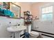 Simple bathroom featuring tile floors, a toilet, and a sink at 506 Currin St, Durham, NC 27703