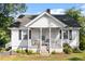 Charming home featuring a covered front porch and a cozy swing at 506 Currin St, Durham, NC 27703